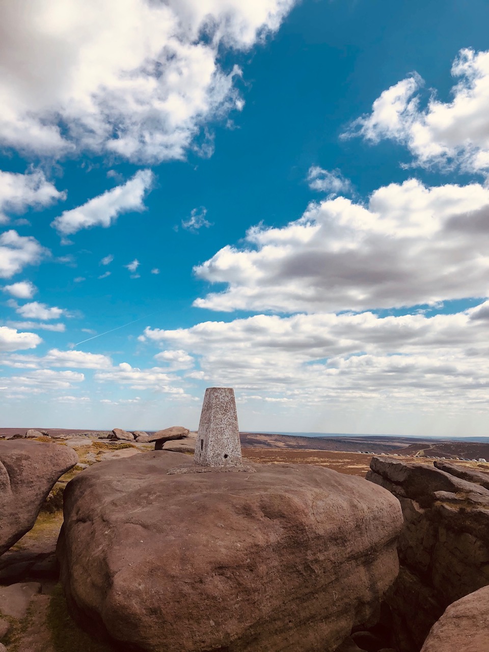 rock formations at Stanage Edge rising from the heather-covered moors of the Peak District
